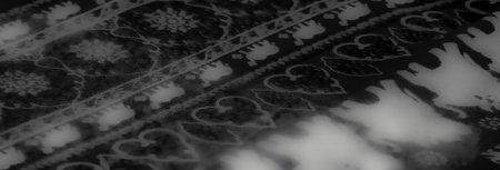 Blur of grayscale fabric adorned with abstract prints and dynamic folds, evoking a sense of movement...