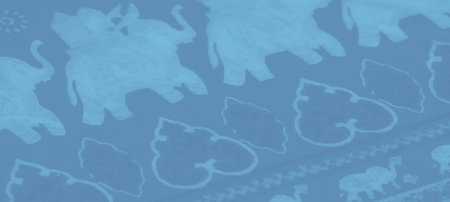 Blur of blue fabric highlighting bold, abstract designs with cultural elements, perfect for artistic...