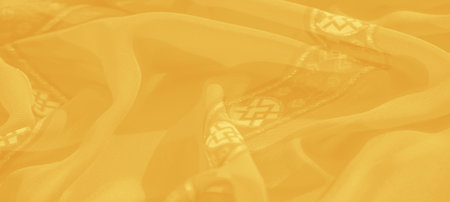 Blur: This yellow fabric features intricate floral and geometric patterns that exude elegance. Its...