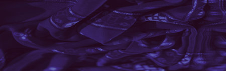 Blur of elegant purple fabric featuring swirling patterns and soft floral accents, evoking a balance...