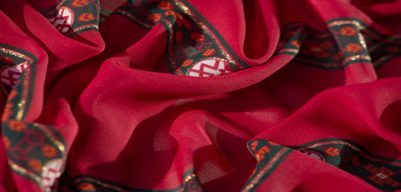 Blur the intricate floral patterns in vivid orange and pink tones on red fabric, featuring accents...