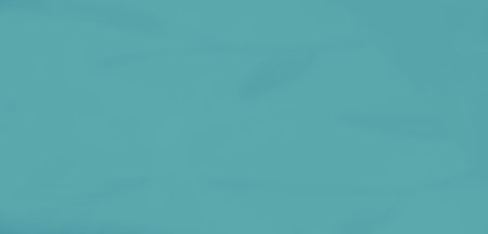 Blurred turquoise fabric with soft folds and a flowing texture, providing an artistic and serene...