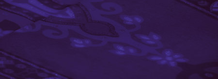 Blurred image of soft purple fabric with shimmering geometric designs and flowing textures, evoking a sense of mystery and elegance ideal for artistic backgrounds.の写真素材