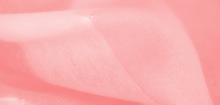 Blur of pastel pink fabric with fine threads and subtle sparkles, featuring intricate folds and a soft texture ideal for artistic or commercial use in design projectsの写真素材