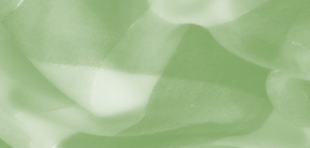 Blur - A soft green fabric with intricate woven threads and gentle folds, creating a subtle and delicate texture ideal for abstract or artistic backgrounds.の写真素材