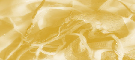 Blur: A soft, flowing yellow fabric with delicate mesh texture and light reflections, creating a soothing and dreamy visual appeal, ideal for abstract or textile concepts.の写真素材