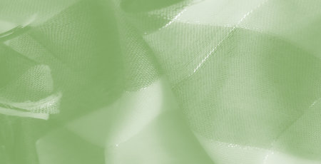Blur - The green fabric, with a translucent appearance and subtle light play, creates an ethereal aesthetic, enhancing its artistic and decorative appeal.の写真素材