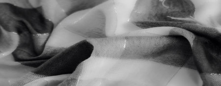 Blur - An intricate view of textured fabric with soft folds in grayscale. The delicate interplay of light and shadow enhances its artistic and minimalistic appeal.の写真素材