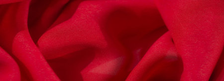 Blur of a vibrant red textile with a soft and velvety appearance, its gentle folds creating depth...