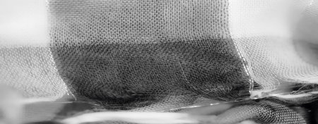 Blur. A softly draped grayscale fabric image with delicate textures and intricate weaving patterns, evoking a sense of sophistication and minimalist beauty.の写真素材