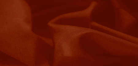 Blurred soft red fabric with natural folds forms an abstract and sophisticated background. Its minimalistic texture adds refinement to any visual project.の写真素材