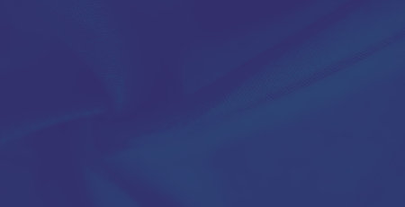 Blurred ripples and creases of blue fabric form an elegant and dynamic composition, emphasizing...