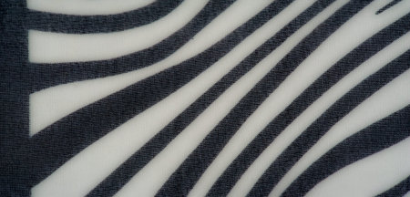Blurred textured black and white fabric with elegant flowing lines and a modern monochromatic design, suitable for fashion, interiors, or creative projects.の写真素材