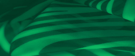 Blur of green fabric with bold abstract stripes flowing across soft textures, creating a dynamic and stylish design with a contemporary aesthetic.の写真素材