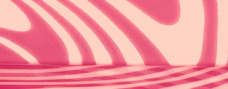 Blurred layers of pink fabric with bold flowing patterns and soft textures, offering a visually striking yet subtle appearance. Great for decorative or artistic purposes.の写真素材