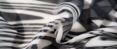 Blur of layered black and white fabric with curved wave patterns. The artistic folds and minimal...