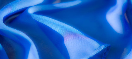 Blur: A vibrant blue fabric captured with soft folds and smooth details, highlighting the elegance...