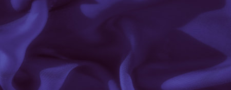 Blurred detailed view of purple fabric with soft, flowing folds and subtle shadows. The texture and weave of the material create a sense of elegance and richness.の写真素材