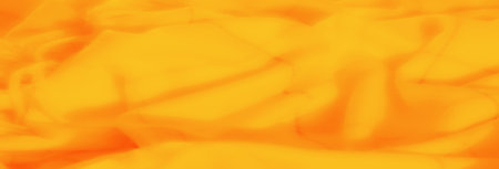 Blurred vibrant orange and yellow fabric swirls with soft folds and visible stitching lines, creating a warm and textured abstract textile design perfect for creative projects.の写真素材