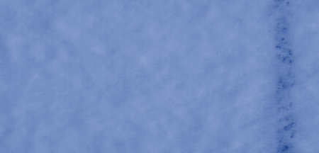 Blurred soft blue fabric with a smooth, flowing texture and subtle folds creating an elegant design. The gentle grid pattern adds a modern touch to the textile.の写真素材