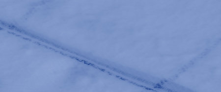 Blur effect captures a close-up of soft, flowing blue fabric with subtle folds and intersecting...