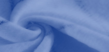 Blur of blue fabric with gentle folds and a minimalistic look. The smooth texture and soft focus are...