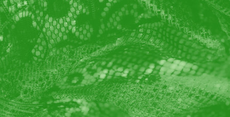 Blur of green mesh with delicate interwoven threads, creating a dynamic interplay of light and...