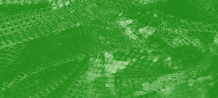 Blur A radiant green fabric with soft folds and sparkling mesh details, displaying a dynamic interplay of light and texture. Ideal for abstract design or textile-themed projects.の写真素材