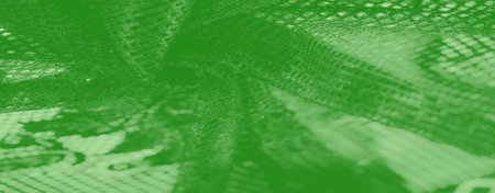 Blurred textured green fabric with a woven appearance and soft, reflective highlights. This abstract material adds depth and a modern aesthetic to any creative project.の写真素材