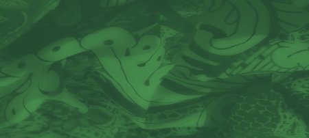 Blur the vivid green textile highlights bold floral and paisley motifs intertwined with geometric elements, offering a dynamic and eye-catching pattern.の写真素材