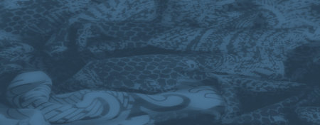Blur of blue fabric with overlapping paisley and floral motifs. The soft textures and delicate folds...