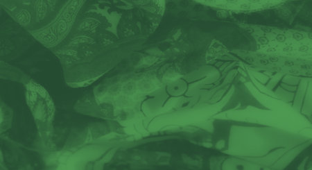 Blur of a vibrant green fabric with intricate paisley patterns and floral motifs, creating a captivating texture and dynamic composition ideal for artistic projects.の写真素材