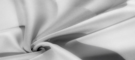 Blur - Elegant grayscale fabric draped in a soft, flowing swirl with smooth textures, creating a serene and modern look.の写真素材