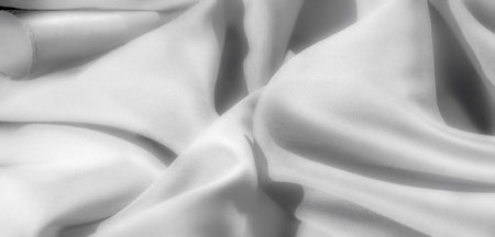 Blur: Abstract swirls and folds of smooth white fabric create a luxurious and seamless texture. Perfect for use in design projects or as a serene background.の写真素材