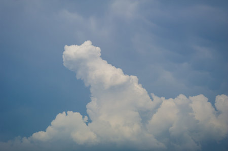 A beautiful panoramic view of fluffy white clouds against a bright blue sky,showcasing a tranquil...