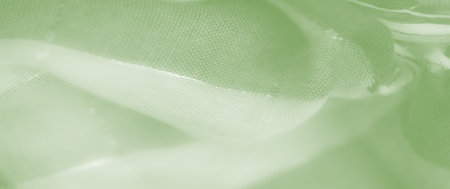 Blur: A green fabric with a shimmering surface and soft curves. The textile reveals intricate...