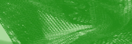 Blur, a luxurious green mesh fabric adorned with shimmering highlights, soft folds, and intricate...