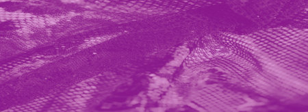 Blur of artistic purple lace fabric with soft, glowing textures and intricate folds. The abstract patterns create a feminine, luxurious, and refined visual appeal.の写真素材