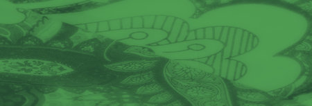 Blur, a detailed floral paisley pattern emerges against a smooth green fabric. Its vibrant, artistic design is perfect for creative textiles and artistic projectsの写真素材