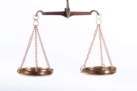 Golden scales of justice, isolated on white background.の写真素材
