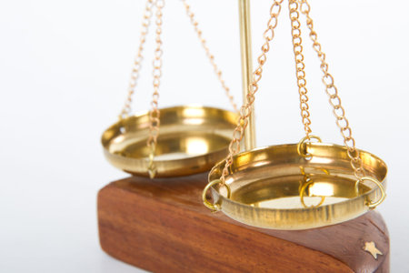 Golden scales of justice, isolated on white background.の写真素材