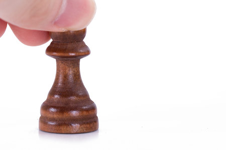 Hand holding wooden pawn with space, isolated on white background.の写真素材