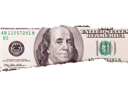 One hundred dollar bill with teared white papers, isolated on white background.