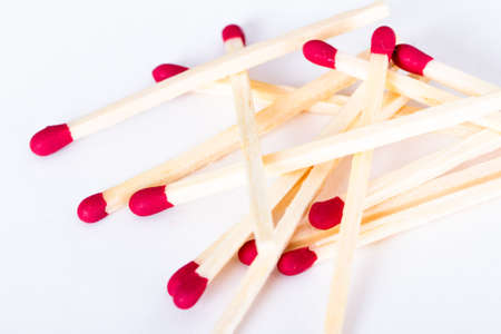 Heap of red headed matches, isolated on white background.の写真素材