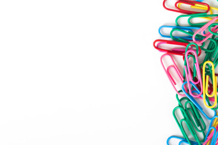 Multi colored paper clips with space, isolated on white background.の写真素材