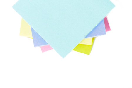 Stack of multi colored sticky post it notes with space, isolated on white background.
