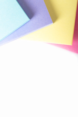 Multi colored sticky post it notes with space, isolated on white background.