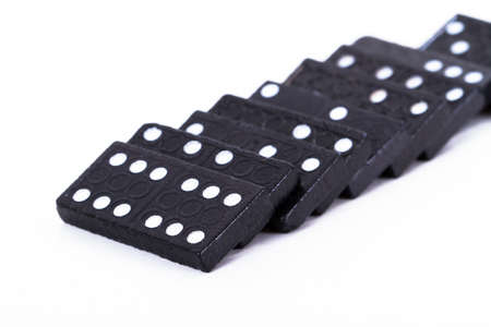 Black dominoes with depth of field, isolated on white background.の写真素材