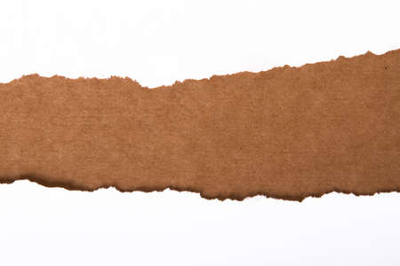 Teared, ripped paper on brown backgroundの写真素材