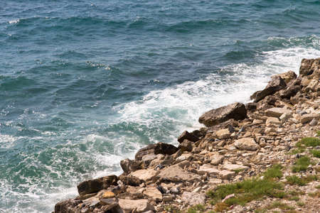Wave of the sea and beach with stones.の写真素材